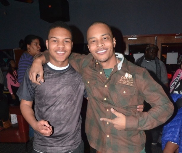 Messiah and his father TI posing for a photo together.